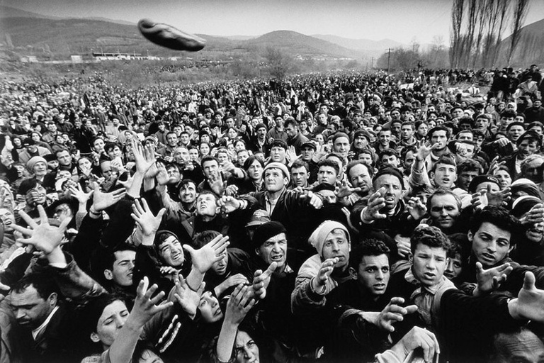 Bread is thrown to Kosovan refugees, prevented from entering the Former Yugoslav Republic of Macedonia.